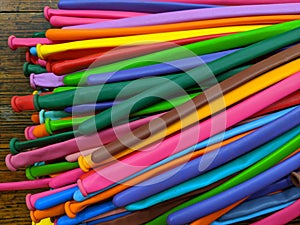 A pile of long thin multicolored modelling balloons