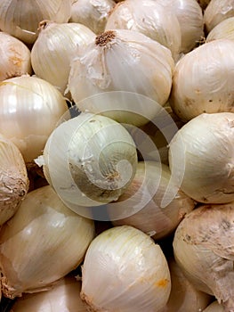 A pile of loose fresh raw white onions