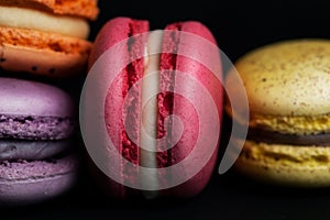 Pile of macaroons on black background