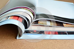 Pile of magazines on table.