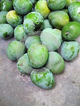 Pile of Mangga Apel Green Mangoes, on Concrete Background