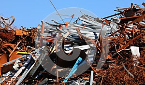 pile of many rusty ferrous scrap from a landfill for recycling