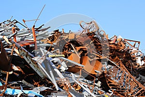 pile of many rusty pieces of iron in the recycling center for th