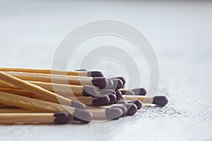 A pile of matches close up on a white table. Macro fire igniter on blurred background