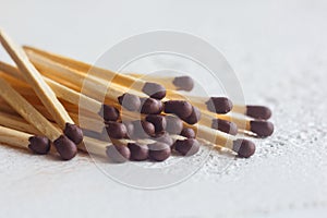 A pile of matches close up on a white table. Macro fire igniter on blurred background