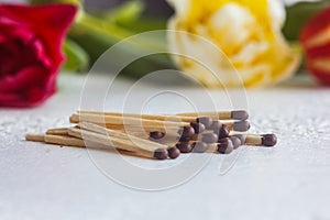 A pile of matches close up on a white table. Macro fire igniter on blurred background
