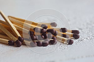 A pile of matches close up on a white table. Macro fire igniter on blurred background