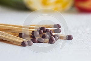 A pile of matches close up on a white table. Macro fire igniter on blurred background