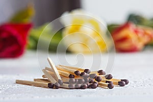 A pile of matches close up on a white table. Macro fire igniter on blurred background