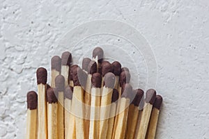 A pile of matches close up on a white table. Macro fire igniter on blurred background. top view