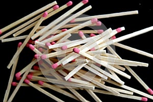 Pile of matchsticks on black background