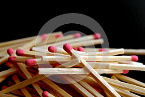 Pile of matchsticks on black background