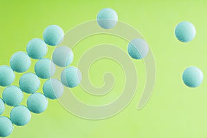 Pile of medical pills on a light glass background