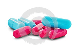 Pile of medical pills in red and blue colors on white isolated background with shadow