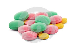 Pile of medical pills in round shape and different colors on white  background with shadow