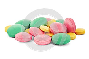 Pile of medical pills in round shape and different colors on white isolated background with shadow