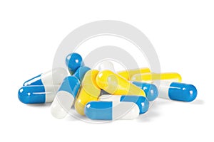 A pile of medical pills yellow and blue