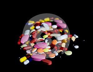 Pile of medicine pills tablets capsules in black background