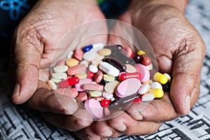 Pile of medicine pills tablets capsules in a both hands