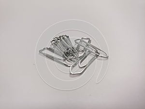 Pile of metal paper clips on a white background