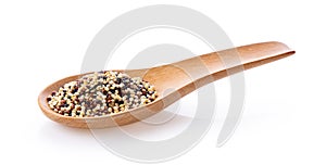 Pile of mixed raw quinoa in wood spoon isolated on white