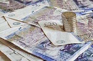 Pile of money and stacked coins british pounds sterling gbp