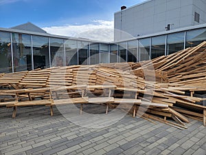 pile or mound of wood tables outside building with windows