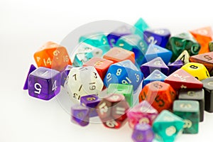 Pile of multicolored gaming dice on a white surface