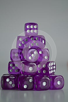 Pile of multiple purple plastic arcylic d6 six sided die dice variable focus