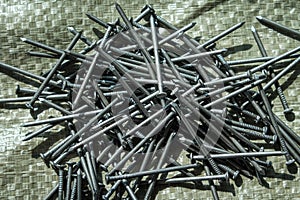 a pile of nails scattered on the building surface