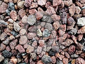 Pile  of natural  brownish porous volcanic rock    stones used to decorate the garden or parts of the house indoor or outdoor