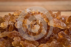 Pile natural rock sugar on wooden background