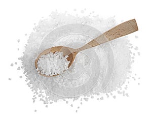 Pile of natural sea salt and wooden spoon on white background, top view