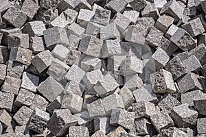 Pile of natural stone cubes for making outdoor pavement tiles.