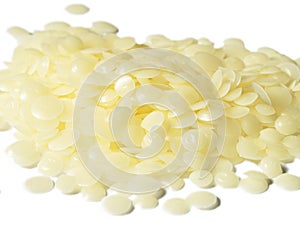 A Pile of Natural White Beeswax Pearls isolated on a White Background