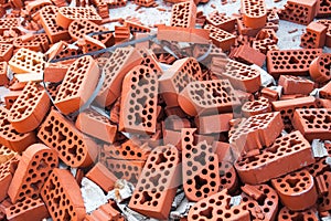 Pile of new intact and beaten bricks