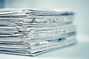 Pile of newspapers on table. Folded and stacked journals