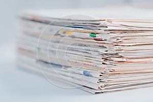 Pile of newspapers on table. Folded and stacked journals