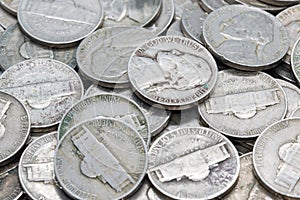 Pile of nickle coins laying on each other