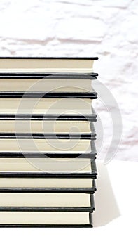 Pile of nine books on white background