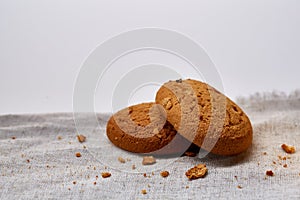 Pile of oat cookies on homespun napkin, close-up, selective focus.