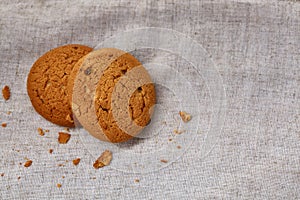 Pile of oat cookies on homespun napkin, close-up, selective focus.