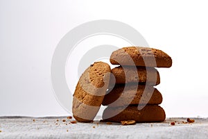 Pile of oat cookies on homespun napkin, close-up, selective focus.