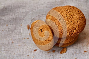 Pile of oat cookies on homespun napkin, close-up, selective focus.