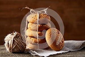 Pile of oat cookies on wooden table, close-up, selective focus.