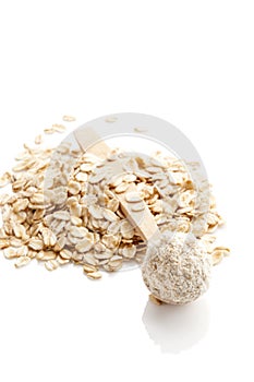 Pile of oat wholegrain flour in spoon