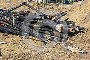 A pile of obsolete metal pipes is excavated from the track