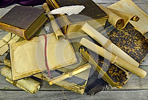 Pile of old books with pocket watch