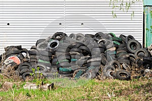 pile of old car tires. Industrial landfill for processing of waste tires, rubber tyres. Waste dump