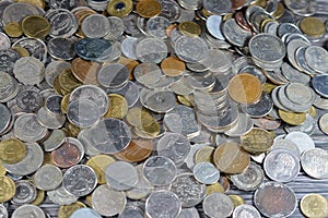 Pile of old coins of different values from different countries of the world, stack of vintage retro old coins from various